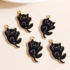 Detail view of five cartoon black cat enamel charms with gold trim for DIY jewelry