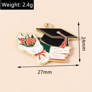 Detail view of 27mm enamel graduation charm with mortarboard and diploma design