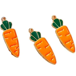Three carrot-shaped enamel pendants with gold alloy edges and vibrant orange finish