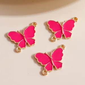 Detail of three rose red butterfly alloy connectors with dual loops for DIY jewelry making