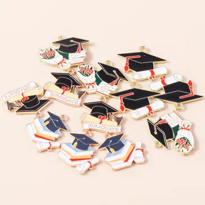 Detailed macro view of graduation charms featuring black mortarboards and scrolls