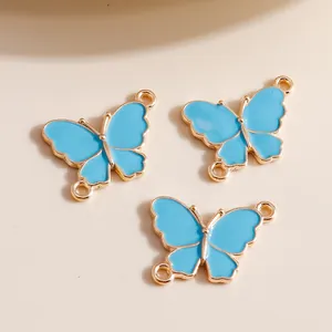 Sky blue enamel butterfly pendant charms with gold alloy edges and dual rings for DIY jewelry