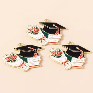 Detailed macro view of graduation alloy charms with mortarboard and rose motifs