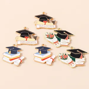 Detailed macro of graduate graduation cap charms with enamel finish for DIY jewelry crafts