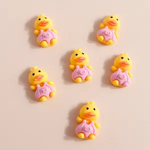 Group of small resin yellow ducks with pink overalls for DIY crafts and phone cases