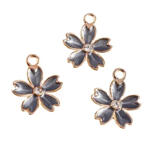 Three gray enamel cherry blossom charms with golden edges and rhinestones for DIY jewelry