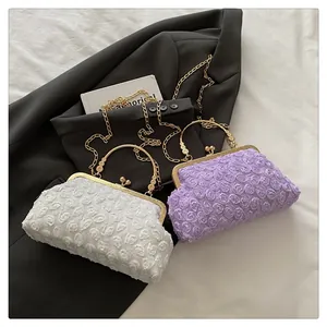 Detail of 3D rose floral evening bags in lavender and cream with golden metal handles