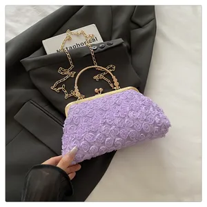 Detail of lavender evening clutch featuring 3D floral texture and golden metal handle