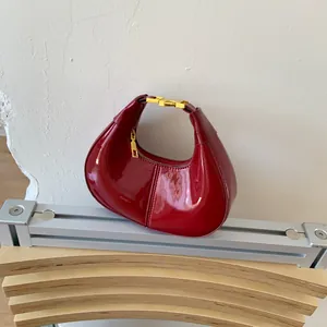 Mini red patent leather hobo bag with high gloss finish and golden square hardware