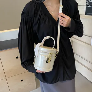 Chic cream white leather bucket bag with silk scarf handle and gold lock hardware