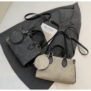 Detail view of contrast tote bags in grey and beige with matching round coin purses