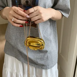 Luxurious gold metal twisted ring evening bag with fine chain strap and mirror finish