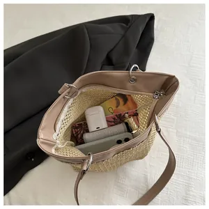 Internal view of woven tote bag with leather strap, zipper closure and daily essentials