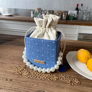 Blue denim cube bucket bag with pearl handle and golden chain strap for women