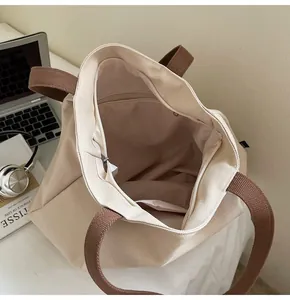 Top view of beige canvas tote bag showing spacious interior with zipper pocket and lining