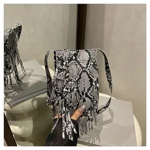 Close-up of snake skin pattern texture and fringe tassels on the shoulder bag