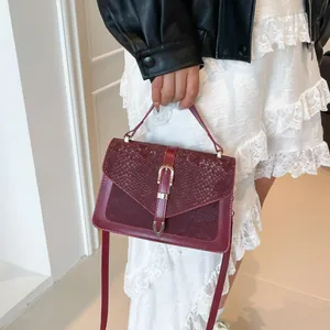 Fashionable dark red snakeskin embossed crossbody handbag with gold metal lock closure