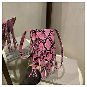 Close-up of pink and black snakeskin texture and long fringe details on the bag