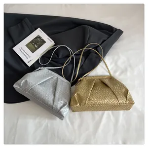 Detail of metallic woven texture shell bags in silver and gold with shoulder straps