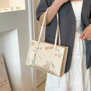 Beige Chinese style embroidery tote bag with floral patterns and green tassel