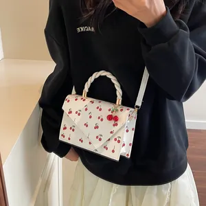Fresh white mini square bag with cherry print and woven handle shown on model
