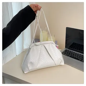 Close-up of white woven textured faux leather shoulder bag with chic pleated cloud design