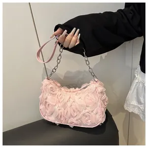Detail of pink 3D floral handbag featuring chiffon rose petals and silver chain strap