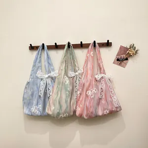 Pastel sheer tote bags with floral embroidery and lace bows in blue green and pink