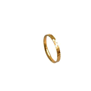 Minimalist golden hammered dragon scale style ring with a shimmering texture finish