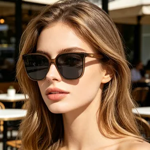 Close-up of translucent brown square sunglasses with polarized lenses and gold wing icon