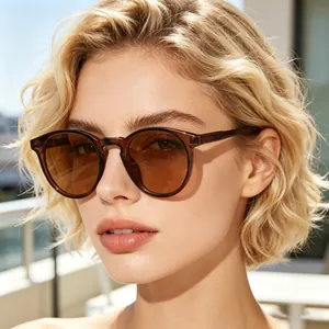 Detail of round amber sunglasses featuring translucent frames and brown tinted lenses