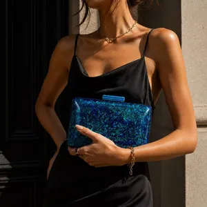 Elegant acrylic shell clutch with blue marble texture and gold chain for evening parties