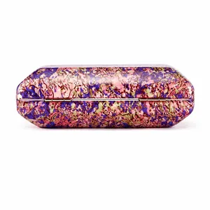 Detail of colorful marble pattern acrylic clutch bag with gold metal hinge closure