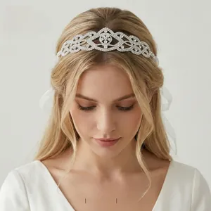 Detailed view of silver bridal headband with luxury rhinestones and white silk ribbons