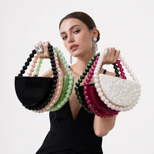 Detail view of acrylic evening bag with oversized beaded handle in various elegant colors