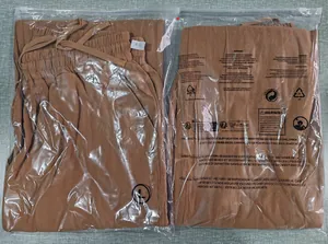 Pantaloni lounge marroni in lino con coulisse elastica in confezione con etichetta taglia L