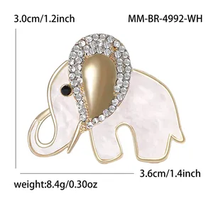 Elegant gold elephant brooch with white shell finish and rhinestones measuring 3.0x3.6cm