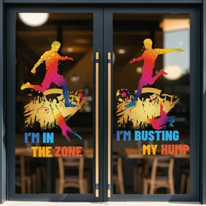 Detail of soccer player silhouettes and inspirational quotes on glass window stickers
