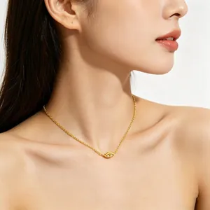 Close-up of a gold S925 sterling silver Evil Eye pendant necklace on female model