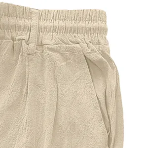 Detailed macro view of linen-style cotton pants waist with elastic band and side pockets