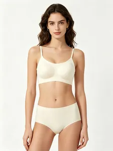 Detailed view of a woman wearing a cream seamless U-neck wireless bra and panty set