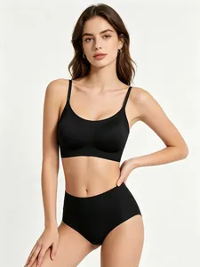 Model wearing a black seamless wireless bra set with a deep U-neck and high-waist briefs