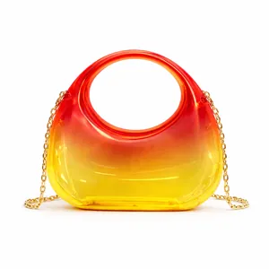 Detail of trendy gradient acrylic handbag featuring a smooth texture and gold chain strap