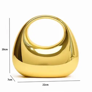 Close-up of golden mirror acrylic handbag showing 22cm x 7cm x 20cm product dimensions