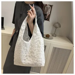 Detailed close-up of white daisy floral lace embroidery on a summer tote handbag
