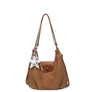 Brown half-moon shoulder bag with star pendant and pleated detail on white background