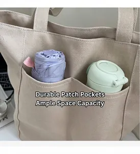 Detail view of durable canvas tote bag showing front pockets with umbrella and water bottle