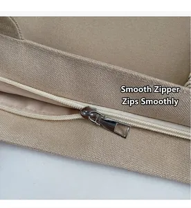 Close-up of smooth metal zipper closure on durable beige canvas tote bag
