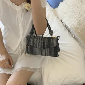 Close-up of woven handbag with tricolor fiber texture and rope handle details