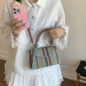 Colorful striped straw handbag with round woven handle and adjustable shoulder strap for women